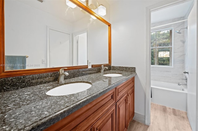 4333 SW 84th Ter, Davie, FL 33328 - full bathroom featuring double vanity, wood finished floors, and tub / shower combination