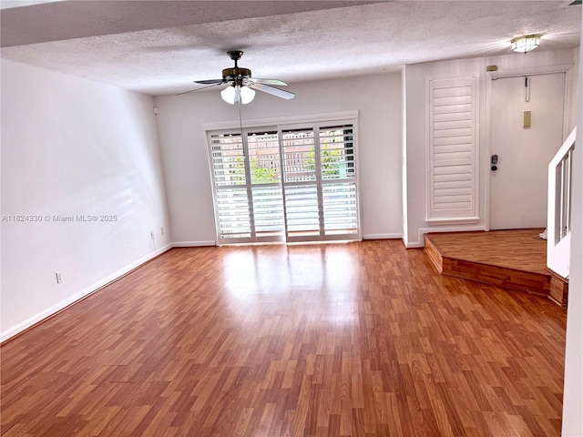 1143 NW 122nd Ter, Pembroke Pines, FL 33026 - spare room featuring wood finished floors, a ceiling fan, and a textured ceiling