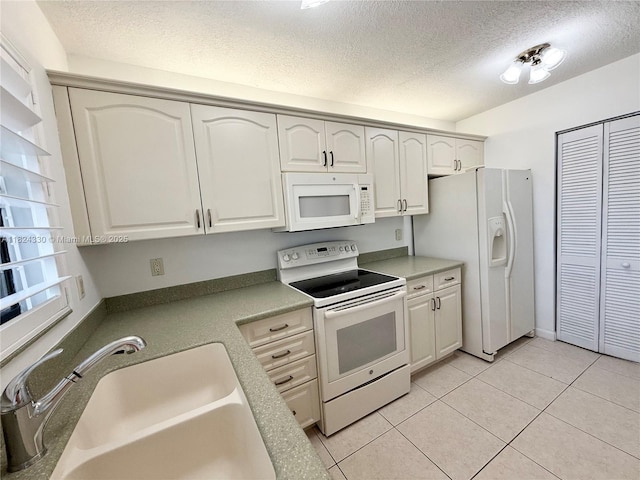 1143 NW 122nd Ter, Pembroke Pines, FL 33026 - kitchen featuring white appliances, a textured ceiling, light tile patterned flooring, and white cabinetry