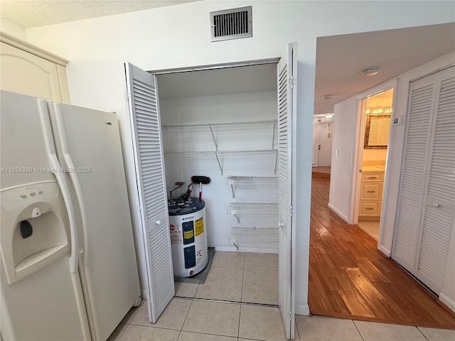 1143 NW 122nd Ter, Pembroke Pines, FL 33026 - washroom with electric water heater and light tile patterned floors