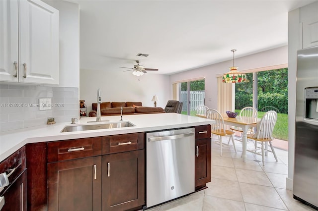 676 NW 133rd Dr, Plantation, FL 33325 - kitchen with stainless steel appliances, light countertops, ceiling fan, open floor plan, and light tile patterned floors