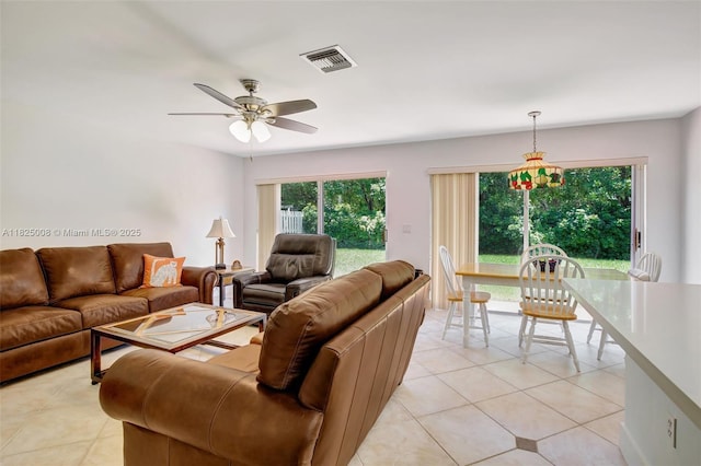 676 NW 133rd Dr, Plantation, FL 33325 - living area with light tile patterned floors, plenty of natural light, and a ceiling fan
