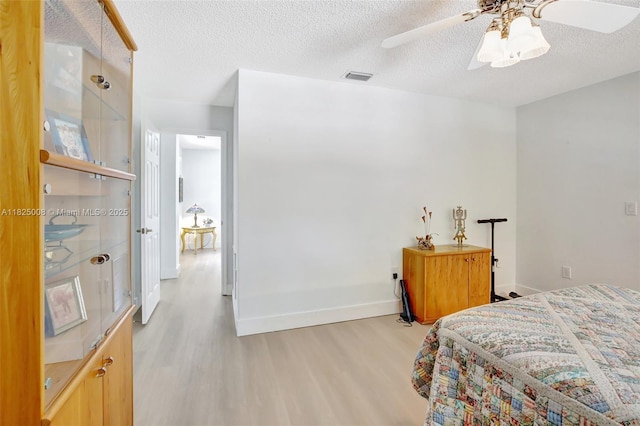676 NW 133rd Dr, Plantation, FL 33325 - bedroom with light wood-type flooring, a textured ceiling, and ceiling fan
