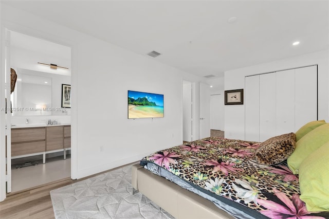 4212 NE 7th Ter, Oakland Park, FL 33334 - bedroom featuring light wood finished floors, a closet, ensuite bathroom, and recessed lighting
