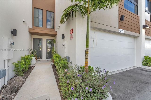 4212 NE 7th Ter, Oakland Park, FL 33334 - property entrance featuring stucco siding and asphalt driveway