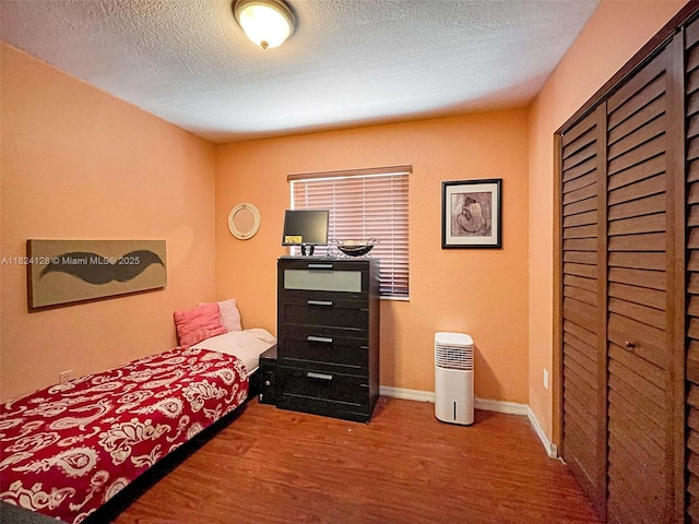 18003 SW 153rd Pl, Miami, FL 33187 - bedroom featuring a textured ceiling, wood finished floors, and a closet