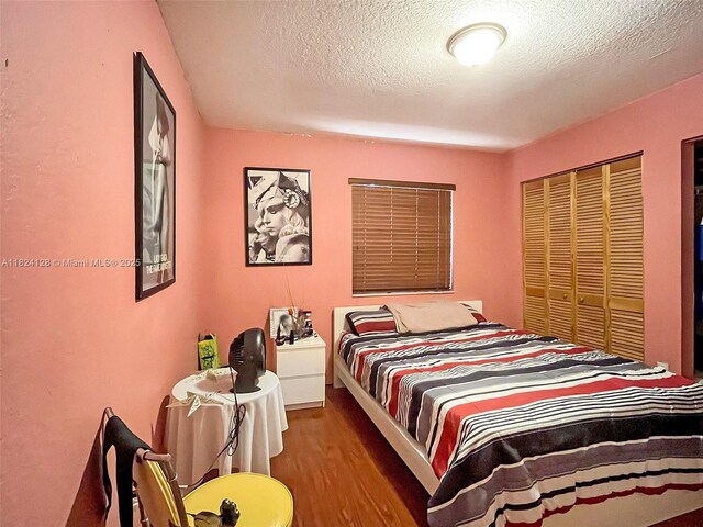 18003 SW 153rd Pl, Miami, FL 33187 - bedroom with wood finished floors, a textured ceiling, and a closet