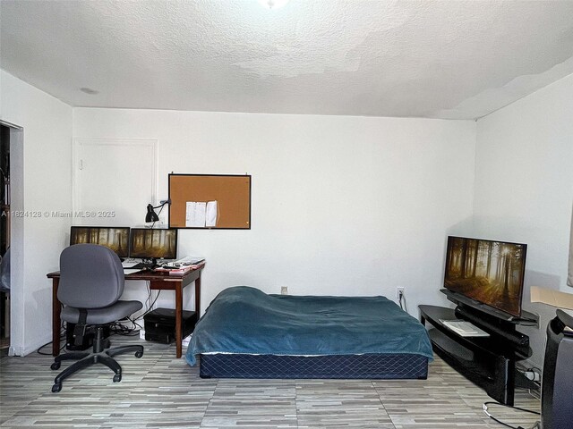18003 SW 153rd Pl, Miami, FL 33187 - bedroom with wood finished floors and a textured ceiling