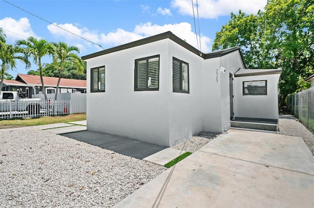 7525 NW 15th Ave, Miami, FL 33147 - view of front of house with stucco siding and a patio