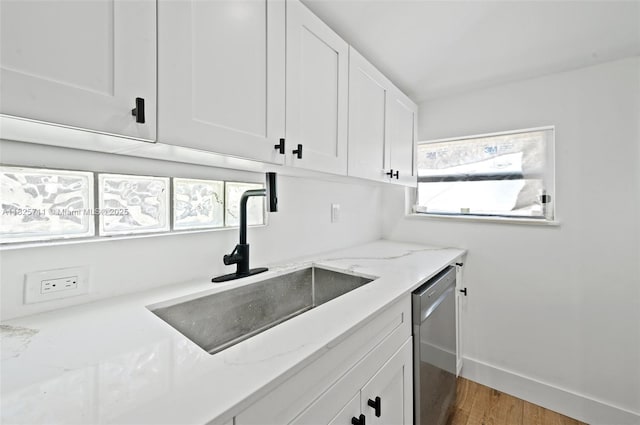7525 NW 15th Ave, Miami, FL 33147 - kitchen with dishwasher, white cabinets, light stone countertops, and wood finished floors
