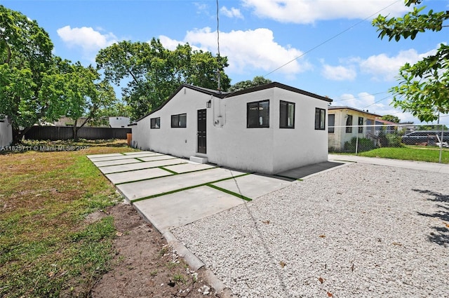 7525 NW 15th Ave, Miami, FL 33147 - rear view of property featuring stucco siding and a patio