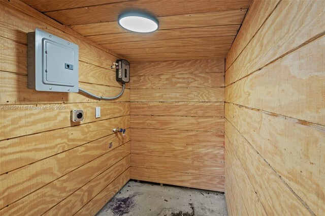 7525 NW 15th Ave, Miami, FL 33147 - laundry view of electric panel, wood walls, wooden ceiling, and unfinished concrete floors