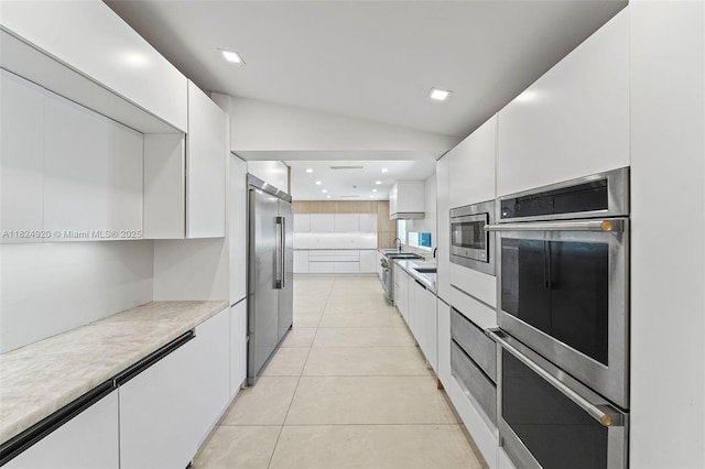 3748 Prairie Ave, Miami Beach, FL 33140 - kitchen featuring built in appliances, white cabinetry, modern cabinets, light countertops, and recessed lighting