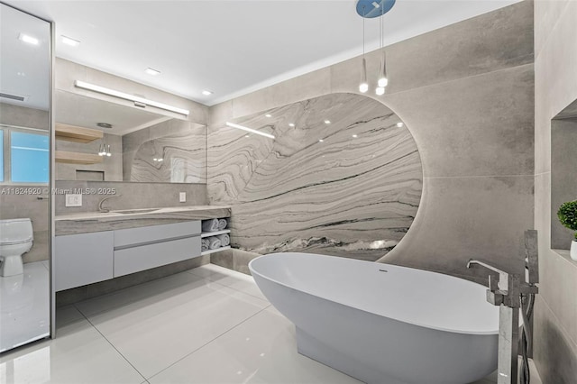 3748 Prairie Ave, Miami Beach, FL 33140 - bathroom featuring tile walls, vanity, and a soaking tub