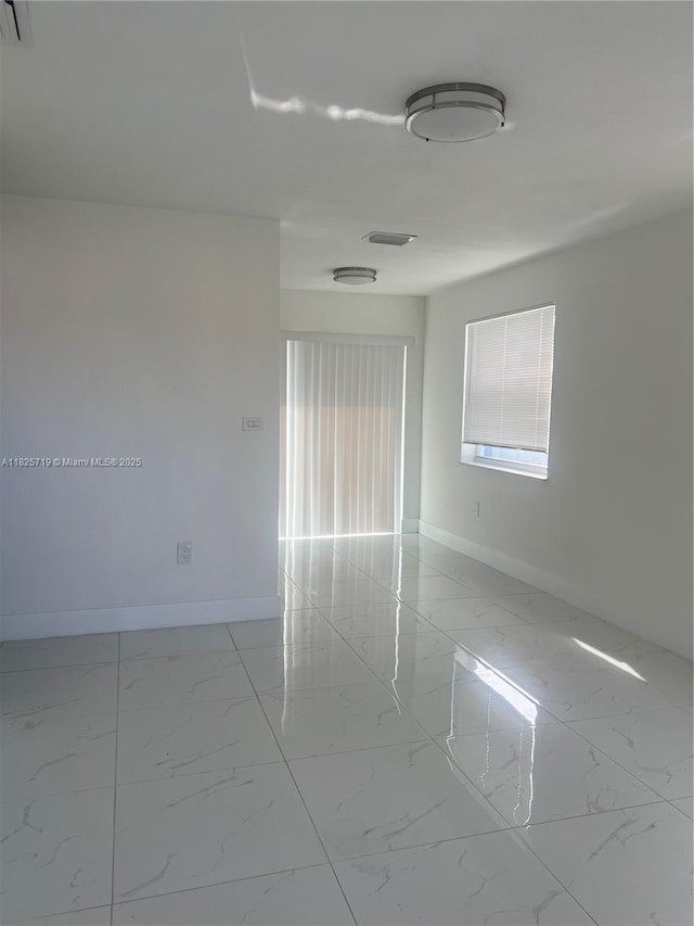 14730 SW 104th Ct, Miami, FL 33176 - unfurnished room featuring light marble finish floors and baseboards