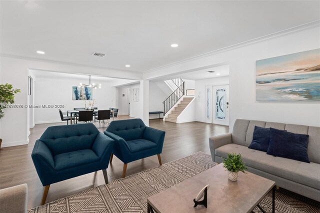 413 Holiday, Hallandale Beach, FL 33009 - living room featuring stairs, wood finished floors, a chandelier, recessed lighting, and crown molding