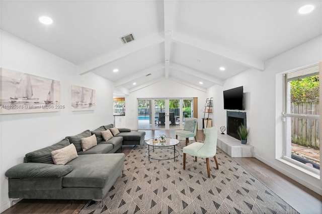 413 Holiday, Hallandale Beach, FL 33009 - living room featuring plenty of natural light, recessed lighting, light wood-style floors, french doors, and a tile fireplace