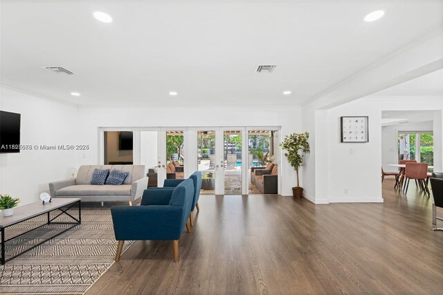 413 Holiday, Hallandale Beach, FL 33009 - living room with french doors, crown molding, wood finished floors, and recessed lighting