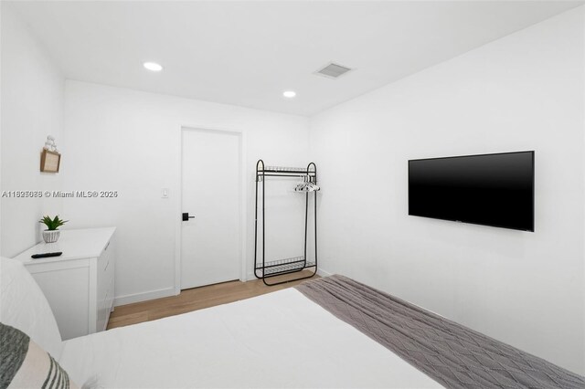 413 Holiday, Hallandale Beach, FL 33009 - unfurnished bedroom with light wood finished floors and recessed lighting
