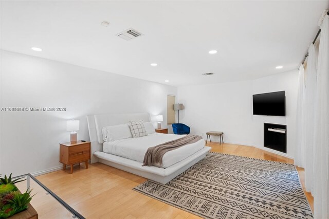 413 Holiday, Hallandale Beach, FL 33009 - bedroom featuring light wood-type flooring and recessed lighting
