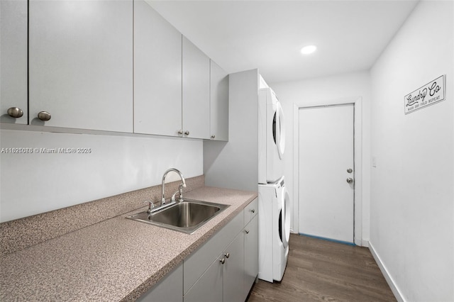 413 Holiday, Hallandale Beach, FL 33009 - kitchen with stacked washer and clothes dryer, dark wood-type flooring, light countertops, recessed lighting, and white cabinets