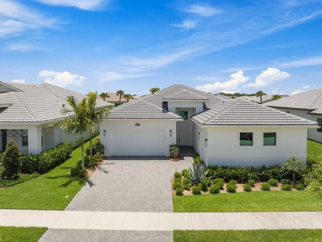 9125 SW Esule Way, Port St Lucie, FL 34987 - view of front of house featuring a garage, driveway, and a tile roof