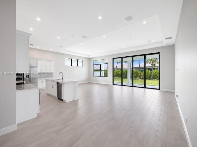 9125 SW Esule Way, Port St Lucie, FL 34987 - unfurnished living room featuring recessed lighting, light wood finished floors, and a raised ceiling