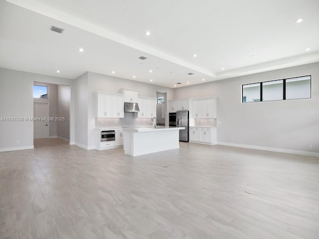 9125 SW Esule Way, Port St Lucie, FL 34987 - unfurnished living room featuring light wood finished floors and recessed lighting