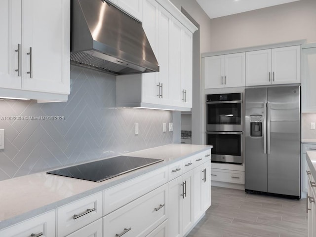 9125 SW Esule Way, Port St Lucie, FL 34987 - kitchen with stainless steel appliances, extractor fan, white cabinets, backsplash, and light stone counters
