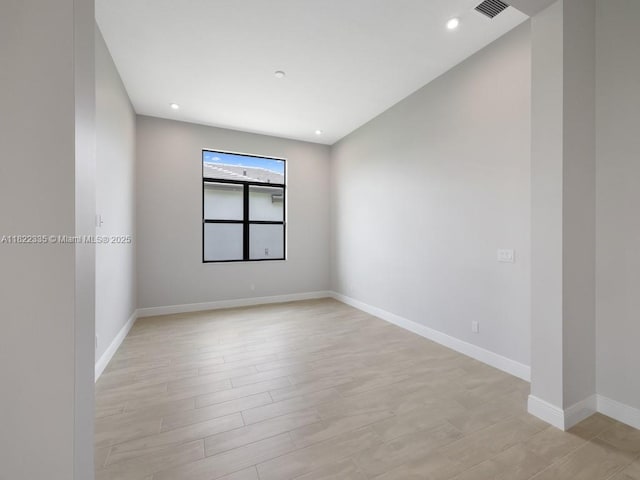 9125 SW Esule Way, Port St Lucie, FL 34987 - spare room featuring light wood-style flooring and recessed lighting