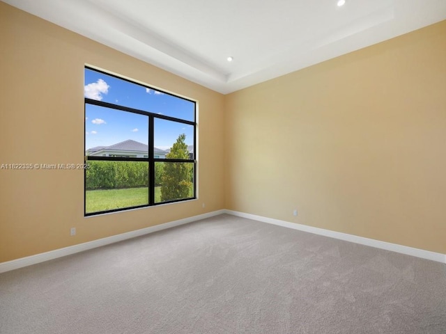 9125 SW Esule Way, Port St Lucie, FL 34987 - carpeted spare room with a tray ceiling and recessed lighting