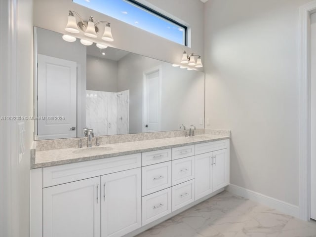 9125 SW Esule Way, Port St Lucie, FL 34987 - bathroom featuring marble look tile flooring, double vanity, and a shower
