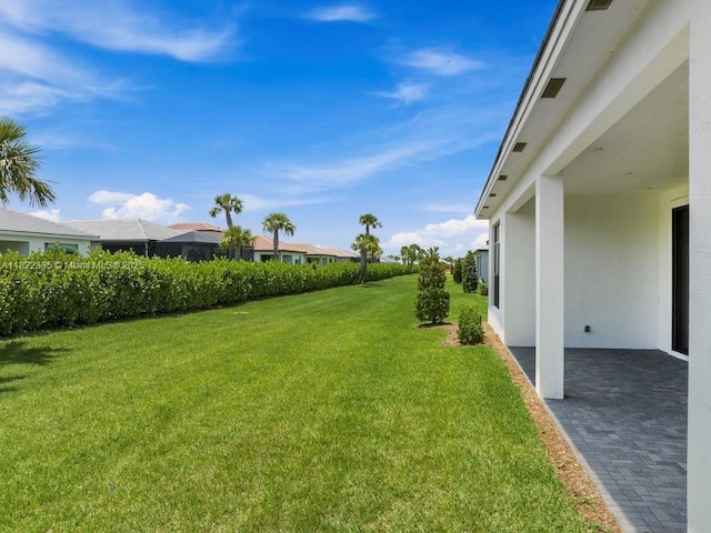 9125 SW Esule Way, Port St Lucie, FL 34987 - view of green lawn with a patio and a residential view