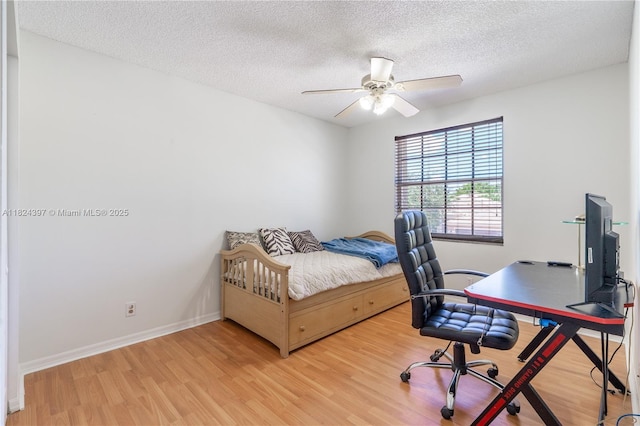 13224 NW 12th St, Pembroke Pines, FL 33028 - bedroom featuring light wood finished floors, a textured ceiling, a desk, and a ceiling fan