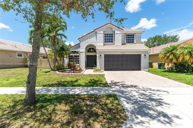 13224 NW 12th St, Pembroke Pines, FL 33028 - mediterranean / spanish house with driveway, a tile roof, an attached garage, and stucco siding
