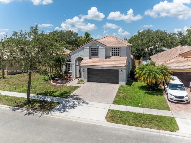 13224 NW 12th St, Pembroke Pines, FL 33028 - mediterranean / spanish house with a tile roof, decorative driveway, a front lawn, stucco siding, and an attached garage