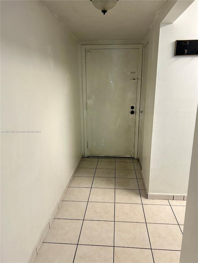 1630 W 46th St Unit 511C, Hialeah, FL 33012 - hallway featuring light tile patterned floors and baseboards