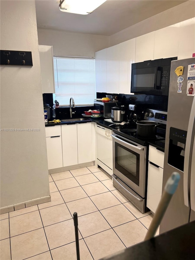 1630 W 46th St Unit 511C, Hialeah, FL 33012 - kitchen featuring stainless steel appliances, white cabinets, and dark countertops
