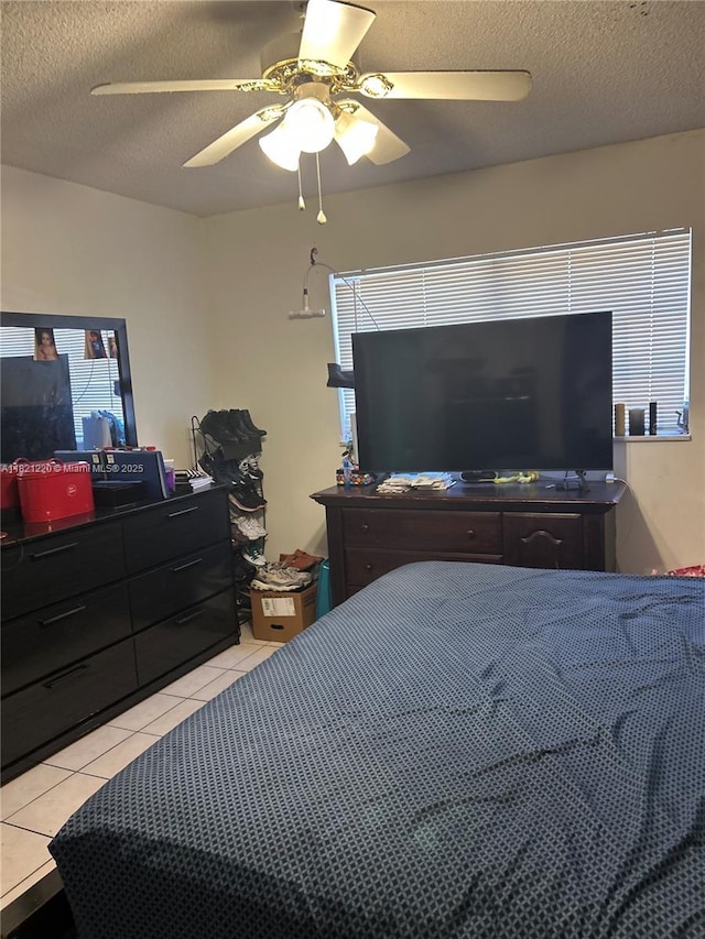 1630 W 46th St Unit 511C, Hialeah, FL 33012 - bedroom featuring light tile patterned flooring, a textured ceiling, and a ceiling fan