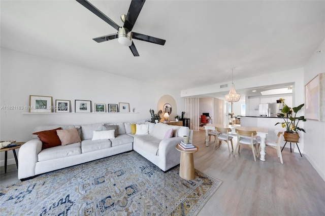 15051 Royal Oaks Ln Unit 1901, North Miami, FL 33181 - living area featuring wood finished floors, a ceiling fan, arched walkways, and a chandelier