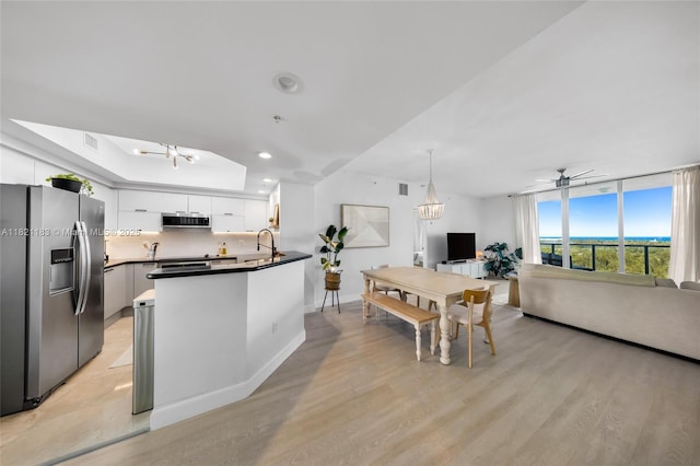 15051 Royal Oaks Ln Unit 1901, North Miami, FL 33181 - kitchen featuring appliances with stainless steel finishes, white cabinets, dark countertops, open floor plan, and recessed lighting