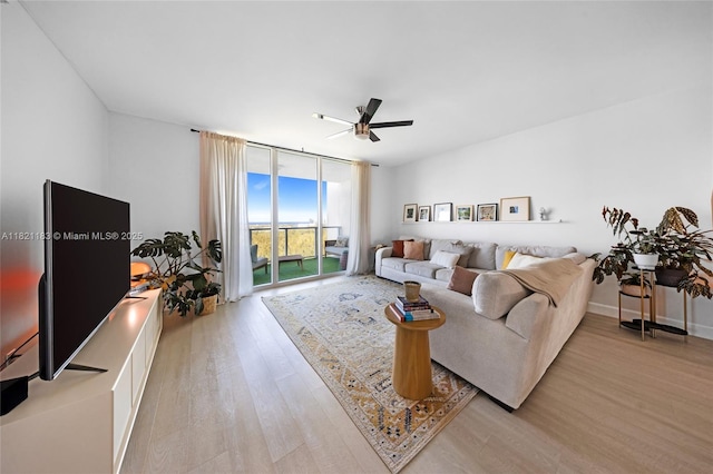 15051 Royal Oaks Ln Unit 1901, North Miami, FL 33181 - living room with a ceiling fan, light wood-type flooring, and a wall of windows