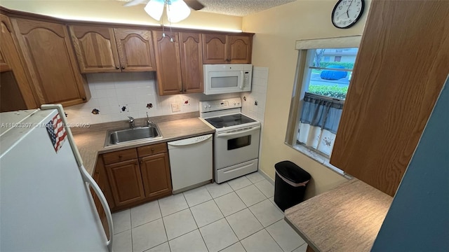 7680 NW 1st St Unit 107, Margate, FL 33063 - kitchen with white appliances, light tile patterned floors, ceiling fan, tasteful backsplash, and a textured ceiling