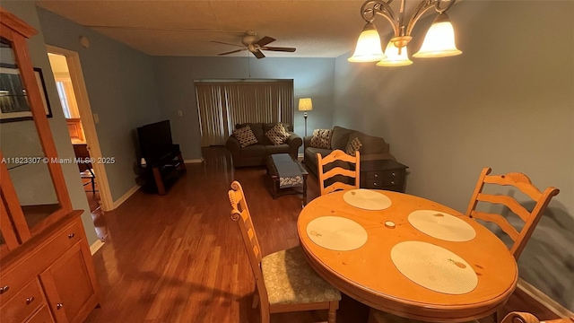 7680 NW 1st St Unit 107, Margate, FL 33063 - dining room featuring ceiling fan, dark wood-type flooring, and a chandelier