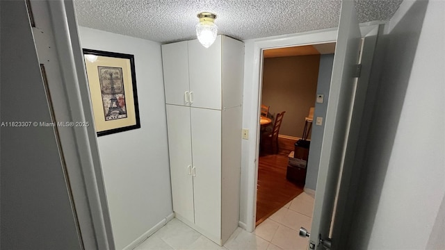7680 NW 1st St Unit 107, Margate, FL 33063 - hallway featuring a textured ceiling and light tile patterned flooring
