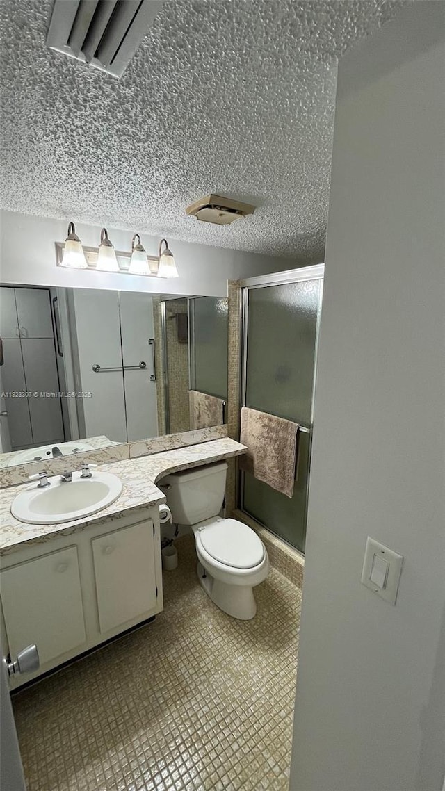 7680 NW 1st St Unit 107, Margate, FL 33063 - full bathroom featuring a stall shower, vanity, and a textured ceiling