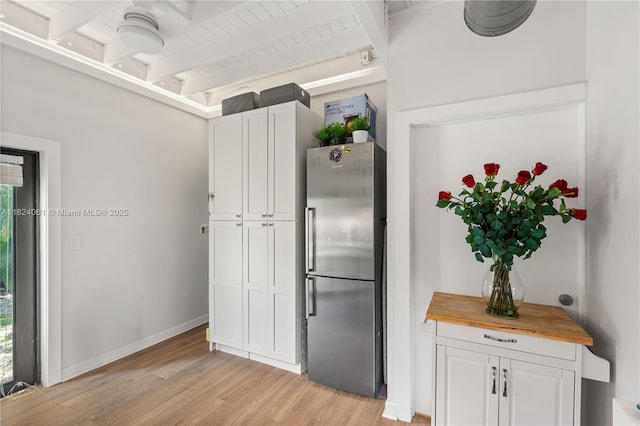1301 Milan Ave Unit 5, Coral Gables, FL 33134 - kitchen with freestanding refrigerator, butcher block counters, light wood-style flooring, white cabinetry, and a wood ceiling with exposed beams