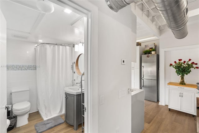 1301 Milan Ave Unit 5, Coral Gables, FL 33134 - bathroom with wood finished floors, a shower with shower curtain, and vanity