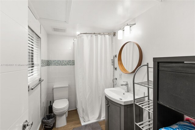 1301 Milan Ave Unit 5, Coral Gables, FL 33134 - bathroom with vanity, wood finished floors, curtained shower, and tile walls