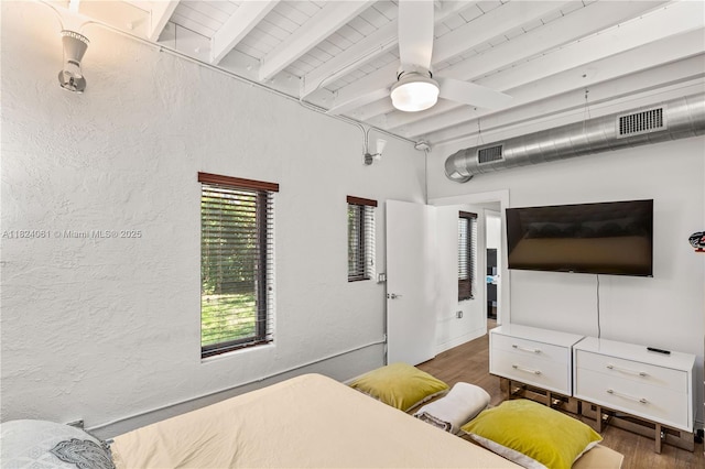 1301 Milan Ave Unit 5, Coral Gables, FL 33134 - bedroom with wood finished floors, beam ceiling, a textured wall, and a ceiling fan